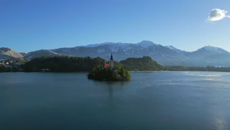 the church of the assumption of mary on a small island in the middle of the calm lake bled in slovenia