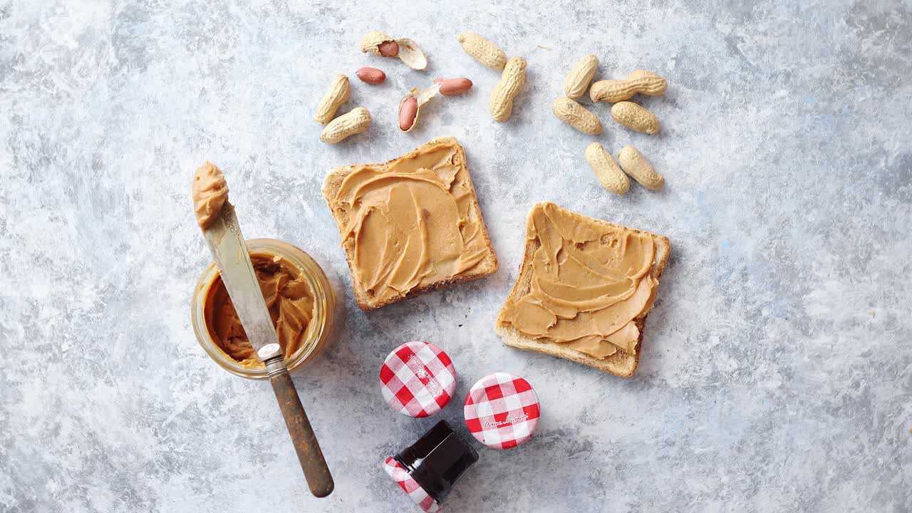 Two tasty peanut butter toasts placed on stone table