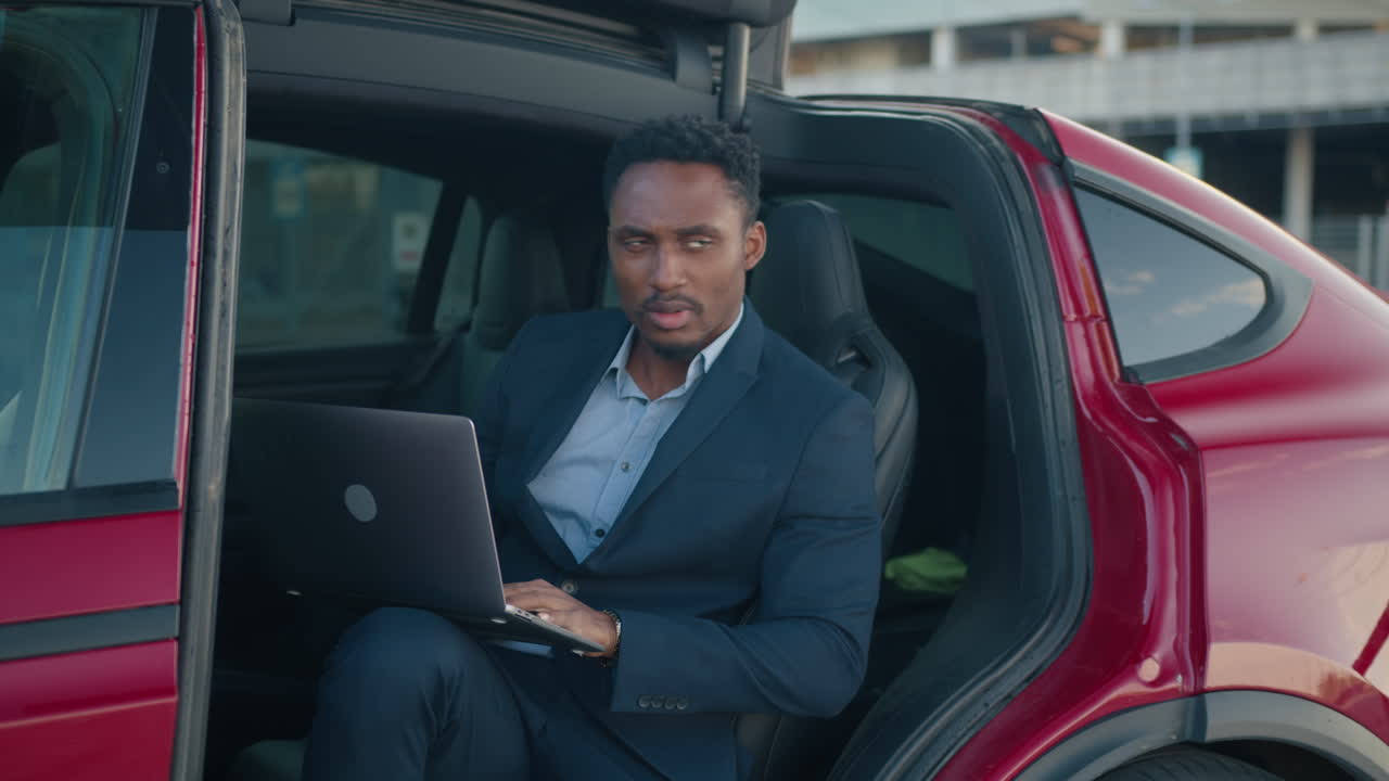Businessman Working in an Electric Vehicle