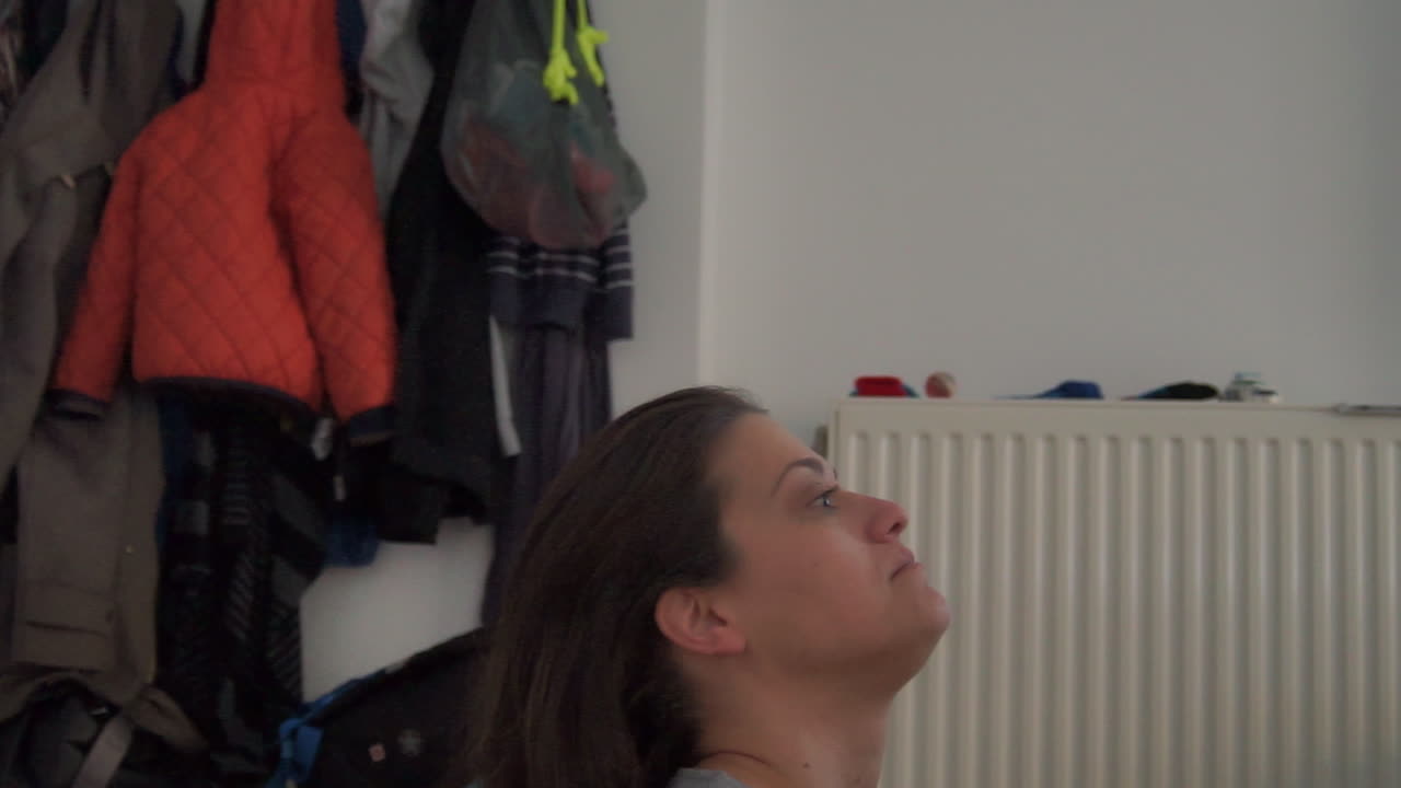 Caucasian mother  is been cared of her little boy indoors having fun fixing her hair