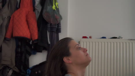 caucasian mother  is been cared of her little boy indoors having fun fixing her hair