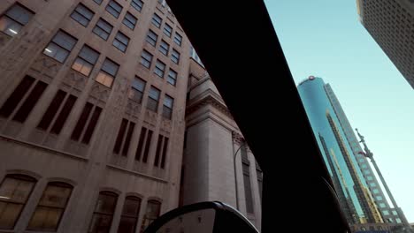 pov shot from car; vintage buildings pass to reveal modern glass and steel skyscrapers