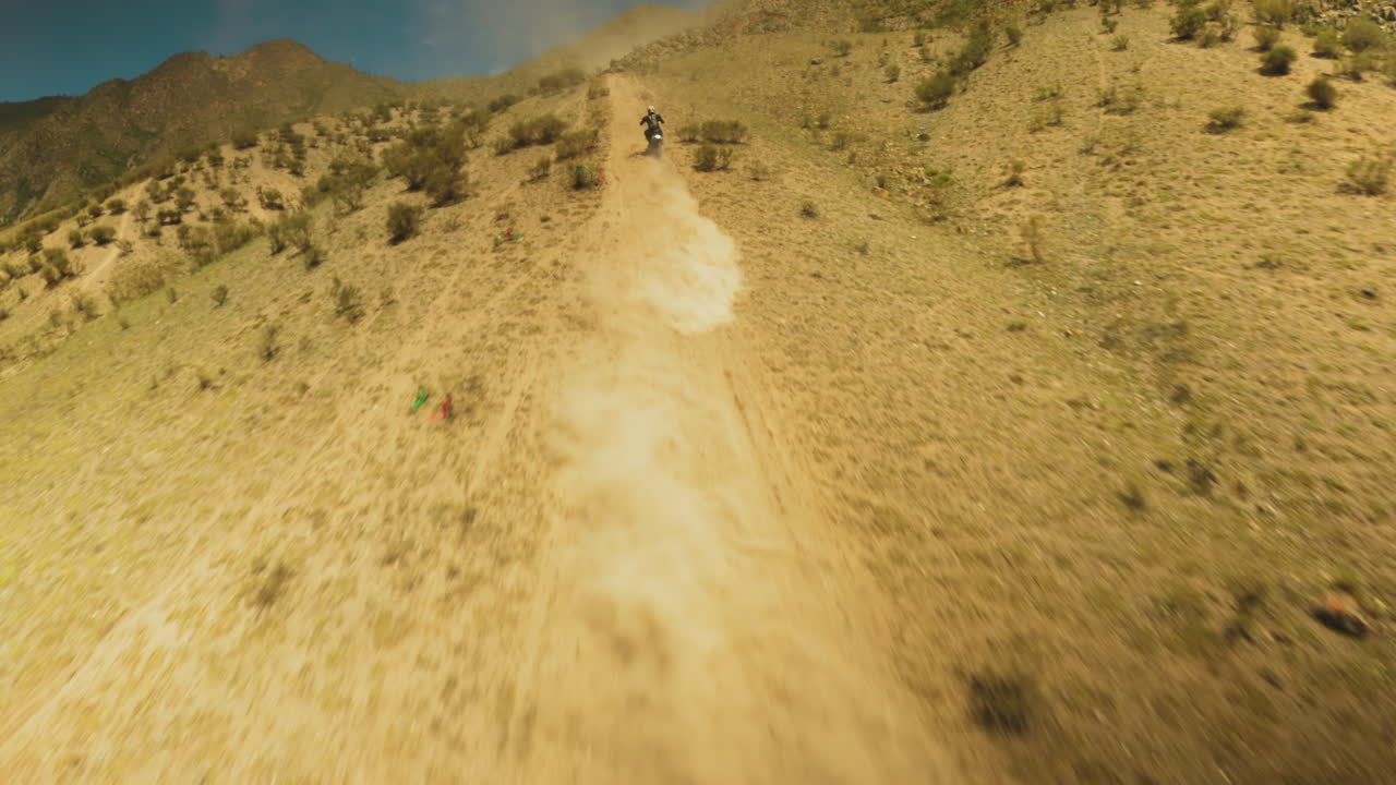 viaje de motociclista por la pendiente fpv drone. vívida ilustración de la pasión y la perseverancia que define la esencia del entrenamiento de deportes extremos. compromiso con la excelencia