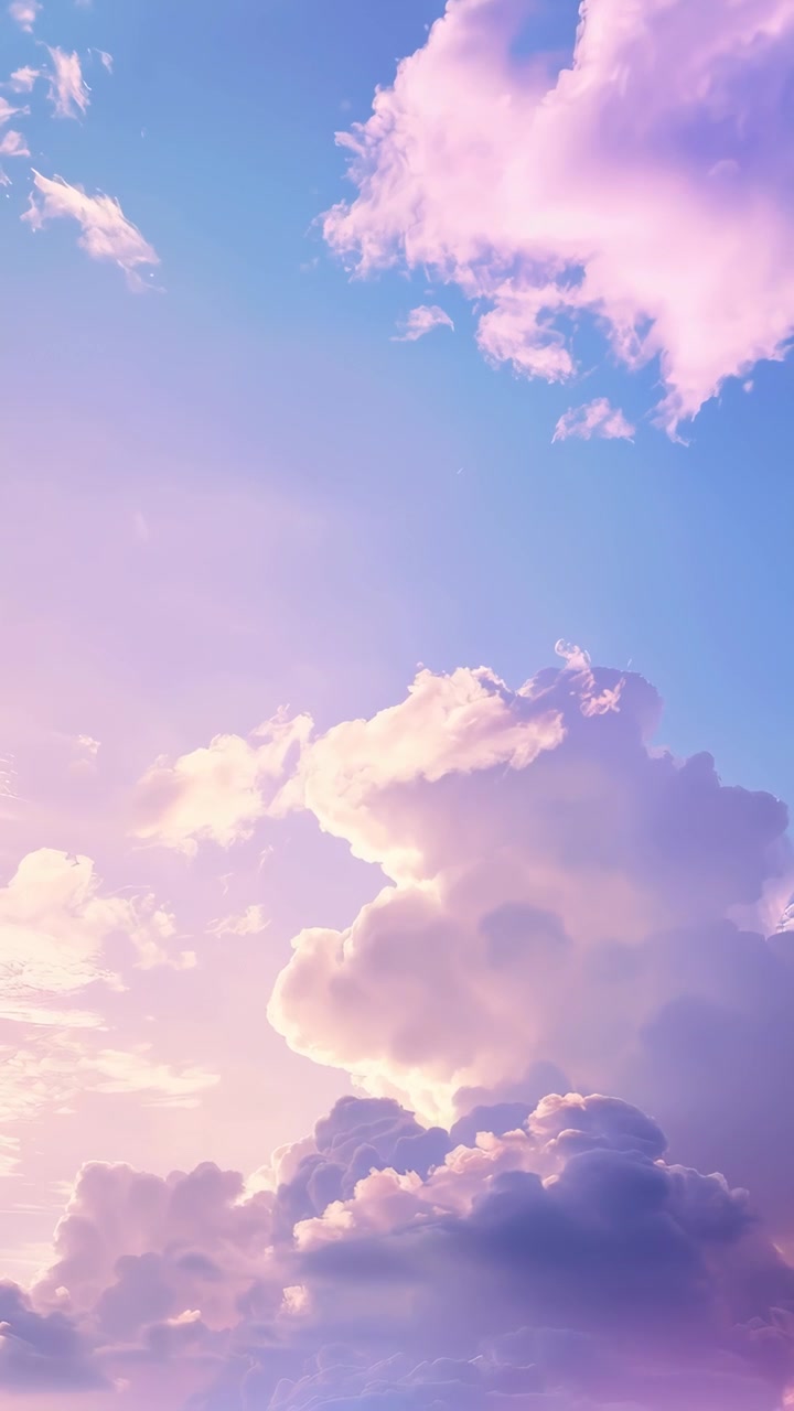 Soft Pastel Clouds Drifting Across a Clear Blue Sky