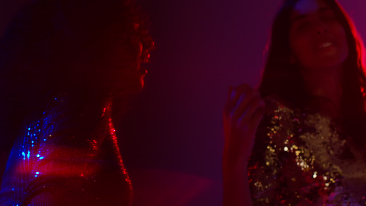 Close Up Of Two Women In Nightclub Bar Or Disco Dancing With Sparkling Lights 3