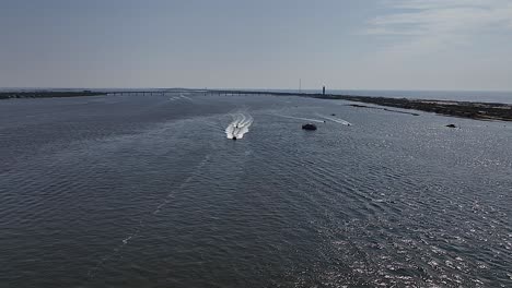 An-aerial-drone-shot-over-the-Great-South-Bay-by-Oak-Beach,-New-York-on-a-sunny-morning