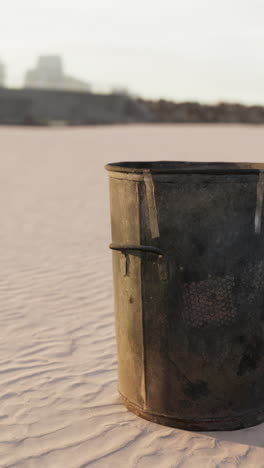 rusty trash can on the beach