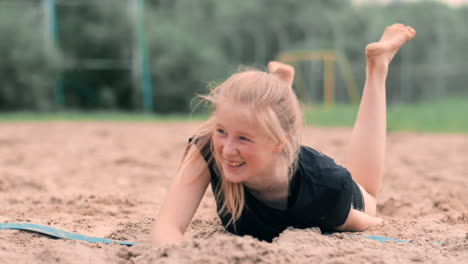 female volleyball player in the fall hits the ball in slow motion on the beach