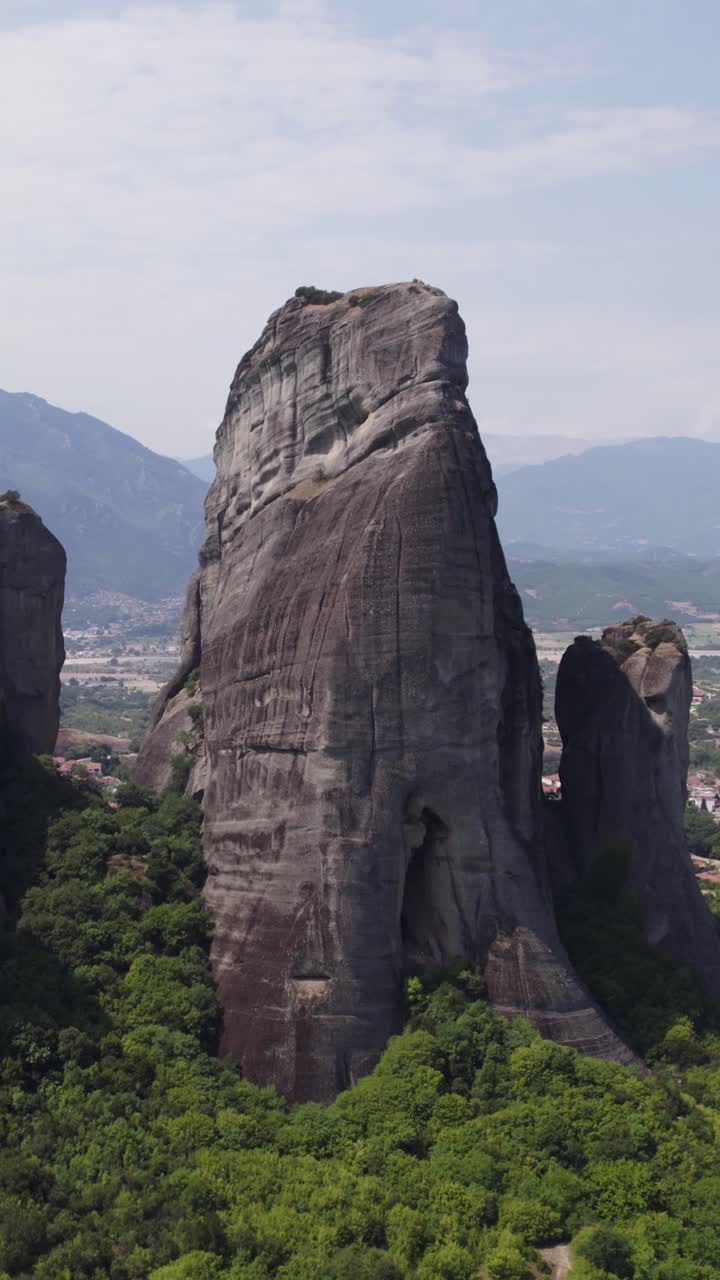 Vertical aerial showcasing Meteora’s famous rock formations and rugged landscape
