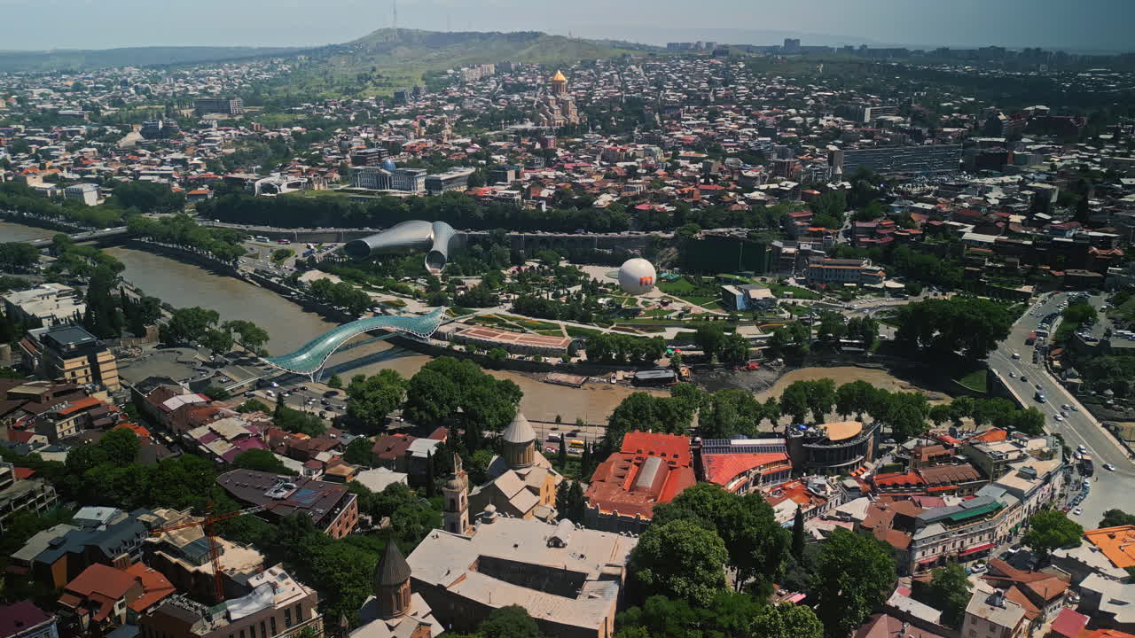 Panoramic Aerial View of Tbilisi Cityscape with Kura River and Bridge of Peace