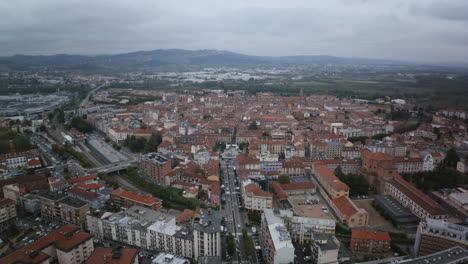 Slow-aerial-hyperlapse-timelapse-of-the-main-street-with-traffic-flowing-in-the-town-of-Alba-in-northern-Italy