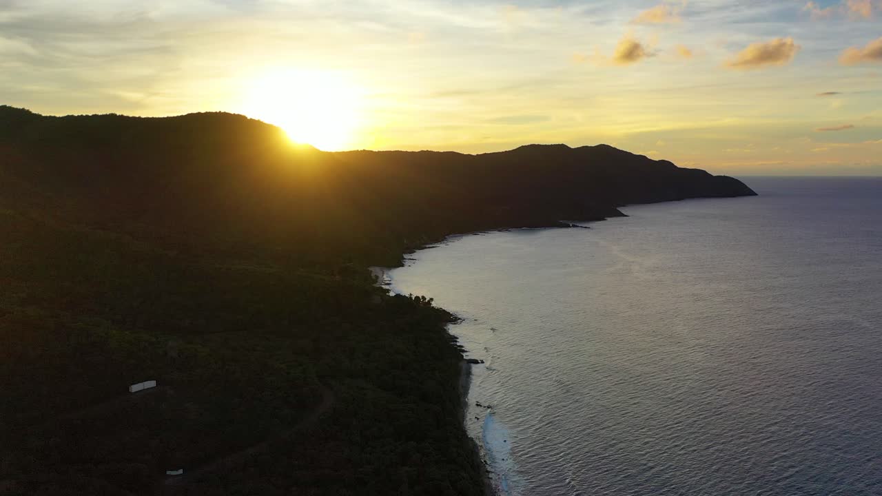 Beautiful sunrise light paints the coast of St. Croix in soft gold, with a tranquil bay, swaying trees, and a peninsula catching the first rays of a peaceful tropical morning