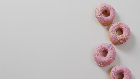 Video-of-donuts-with-icing-on-white-background