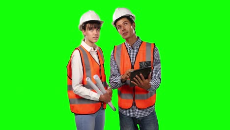 front view of site workers using digital tablet with green screen