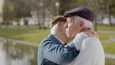 elderly couple dancing at pier in city park on warm autumn day