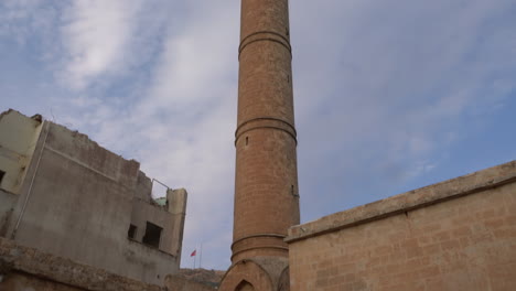 beautiful yellow stone minaret of abdullatif mosque from tip point to down in mardin old town