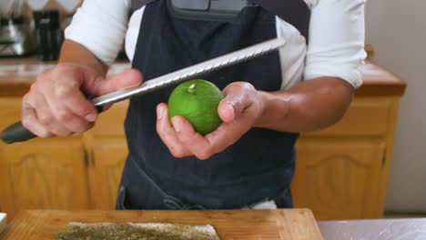 chef adding limon zest onto fish