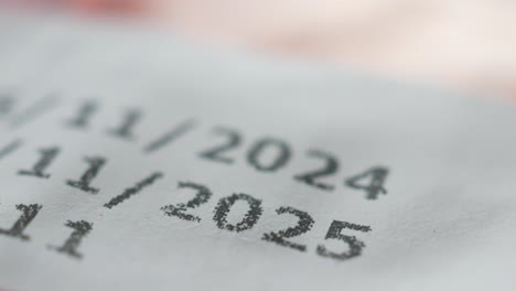 close-up of a date stamp with the years 2024 and 2025 printed on paper.