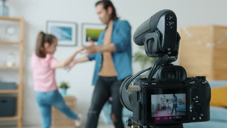 father and daughter dancing at home