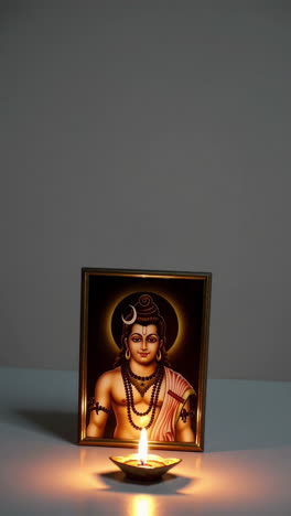 hindu deity with oil lamp