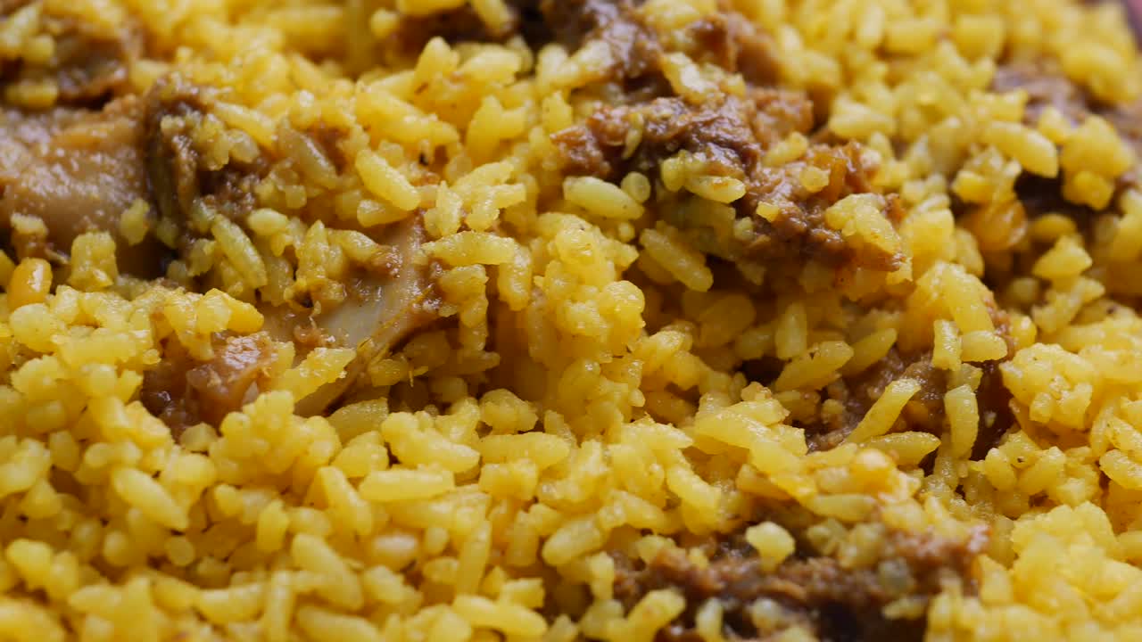 Boiled yellow rice with meats on a plate | Premium Stock Video Footage