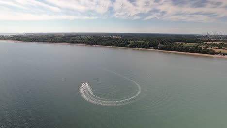 speedboat leaving backwash on the solent strait near the calshot in the united kingdom