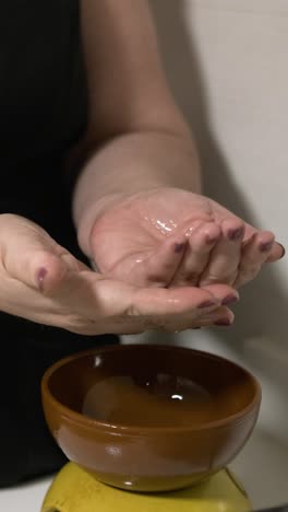 beautician skillfully preparing massage oil for relaxing treatments. vertical