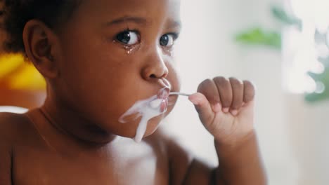 baby eating yogurt