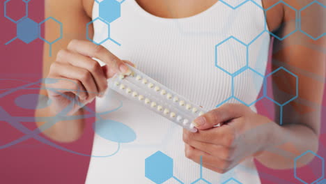 Animation of chemical structures over biracial woman taking pills