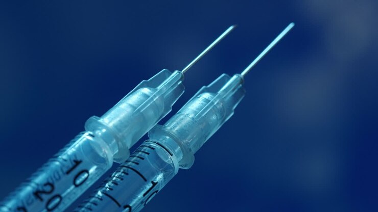 Two syringes for vaccination or medical treatment - macro focus pull along the syringe to the tip of the needle