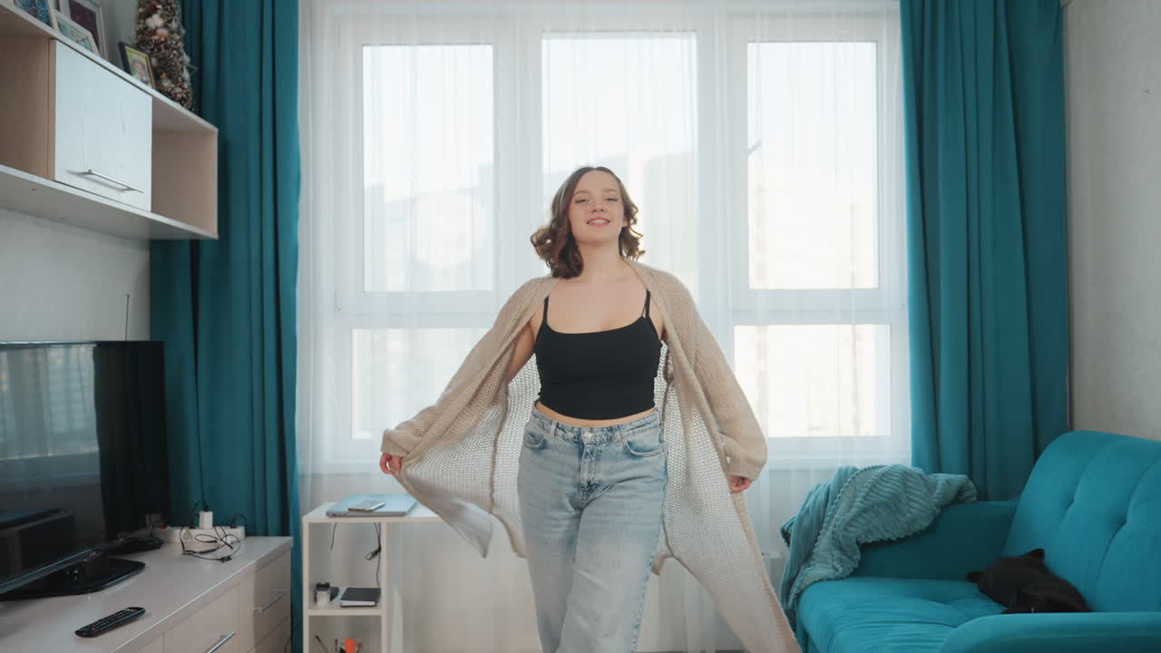 Relaxed Lady In Casual Attire, Selfassured Woman Confidently Moving Around Cozy Living Space, Composed Woman Leisurely Walking Through Her Comfortable And Inviting Living Room Environment