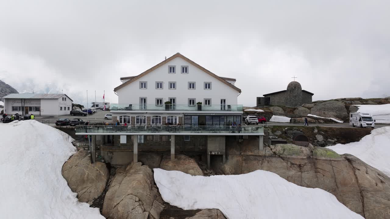 Hotel Grimsel Passh&ouml;he or Grimselpass in Switzerland seen from Totensee or Titinsee Lake