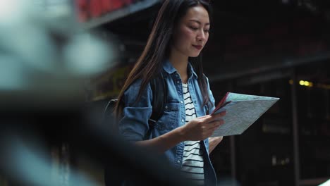 handheld view of tourist looking at the directions from map