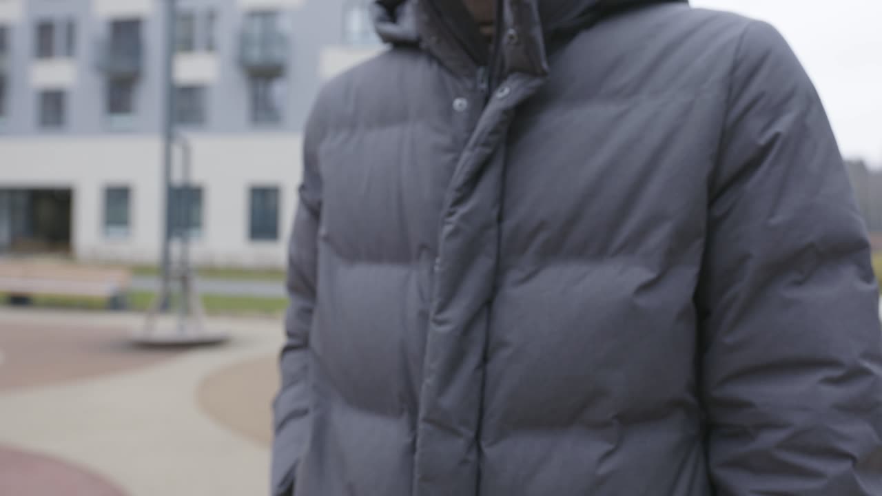 Person using a smartphone outdoors in winter