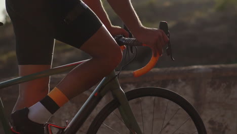 Slow-motion-shows-the-athlete-riding-a-bicycle-along-a-mountain-serpentine,-admiring-the-picturesque-island-scenery,-symbolizing-the-commitment-to-a-healthy-lifestyle