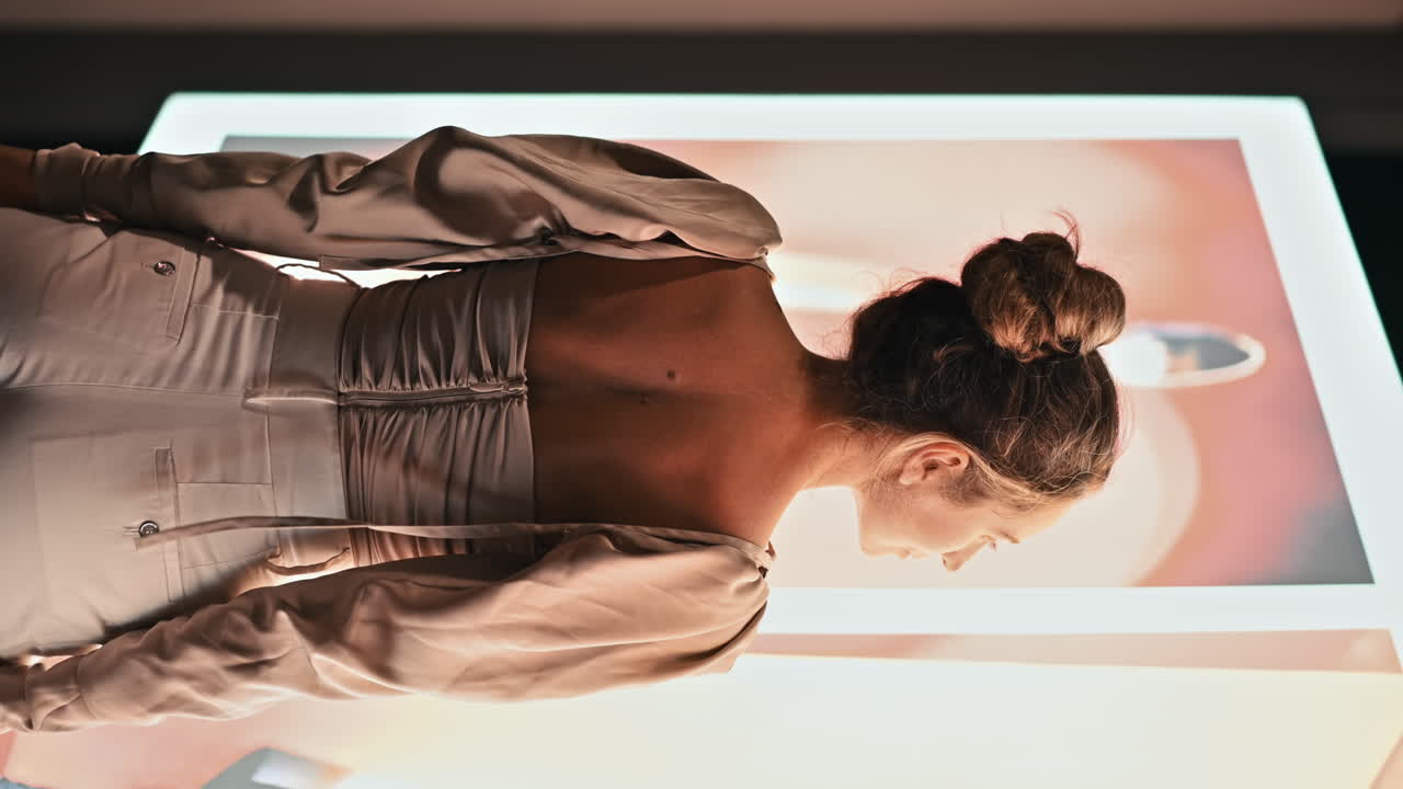 Caucasian smiling woman posing in Cannes at night, illumination, France