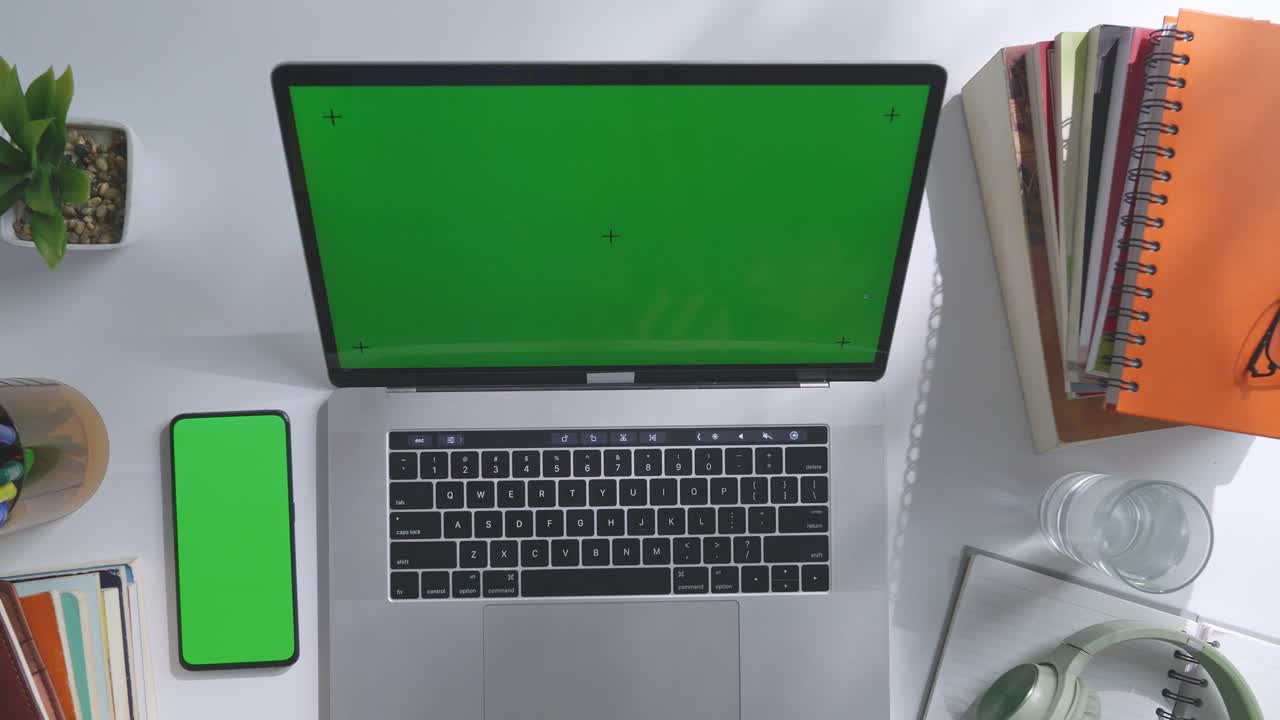 Flatlay of a student workspace with laptop, notebooks, and other study materials