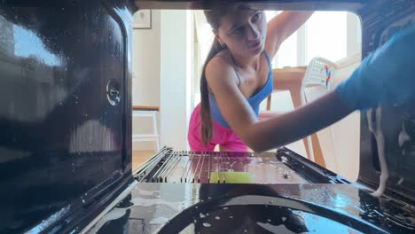 woman cleaning oven