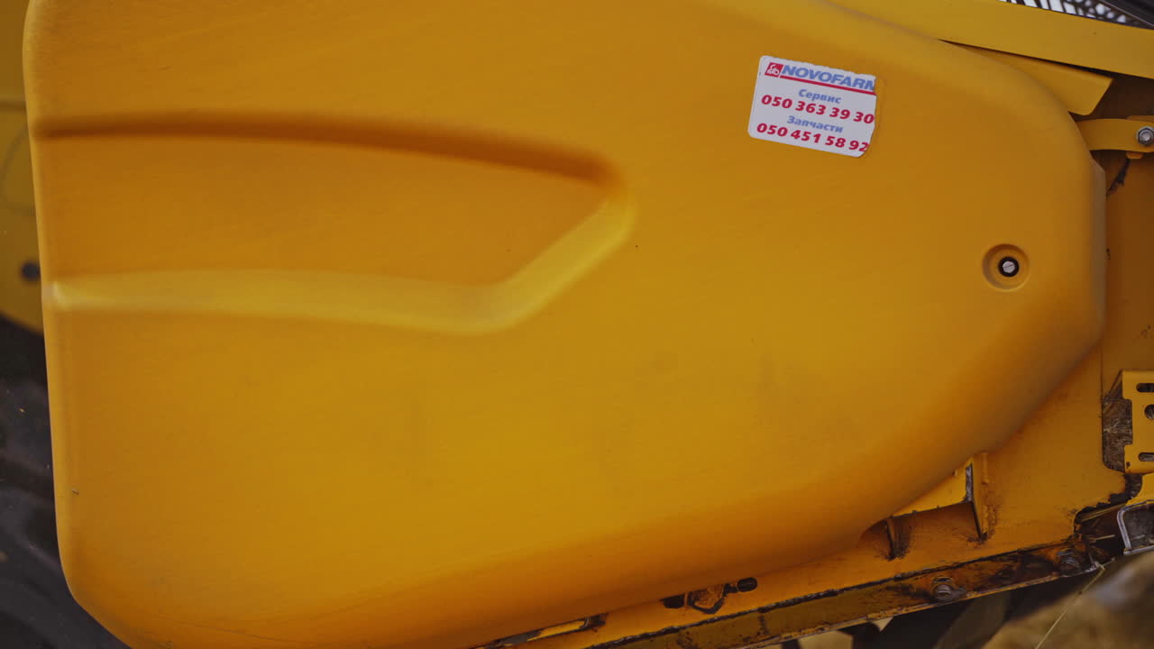 Combine harvests wheat. Close up view of modern combine harvester in action