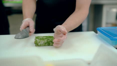 cook cuts japanese rolls with dill