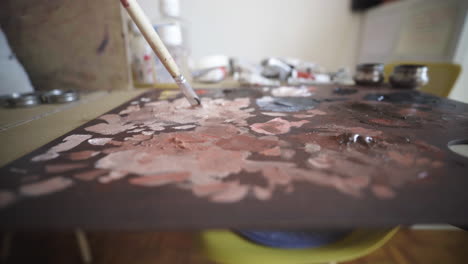 smudging pallete paint with brush at diy studio