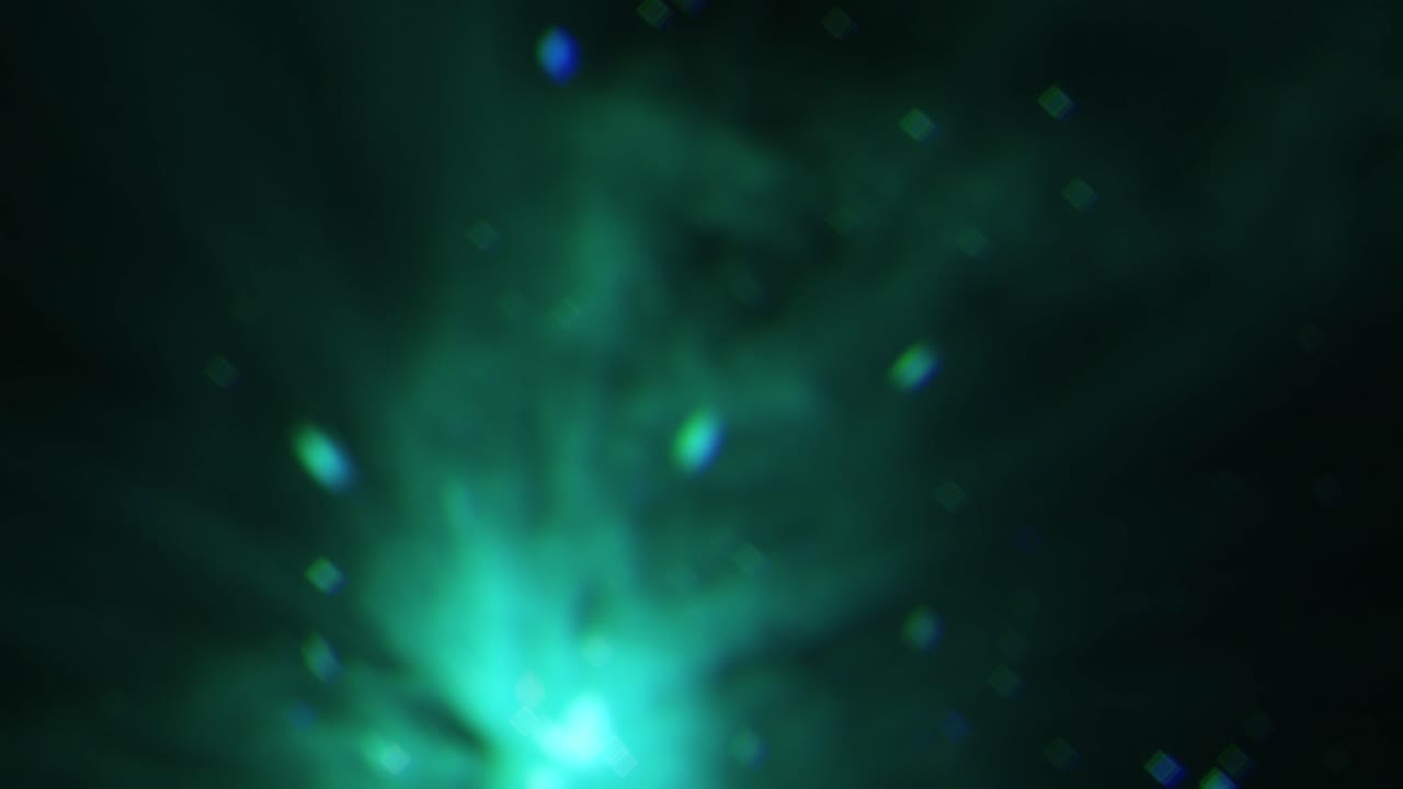A strange, green light through smoke, dancing with floating out of focus square bokeh