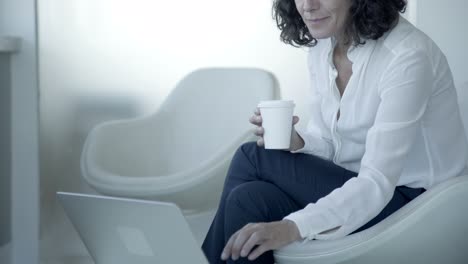 Middle-aged-businesswoman-using-laptop