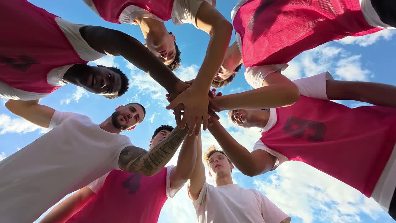 Team of athletes celebrating together under a blue sky