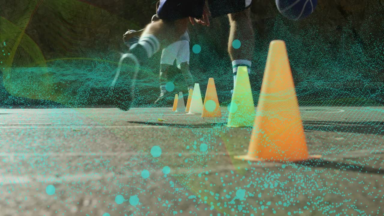 Two athletes picking up basketball and dribbling through cones in sports training boosting agility