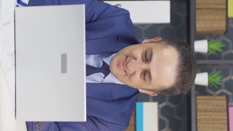 Vertical-video-of-Businessman-looking-at-laptop-screen-with-excitement.