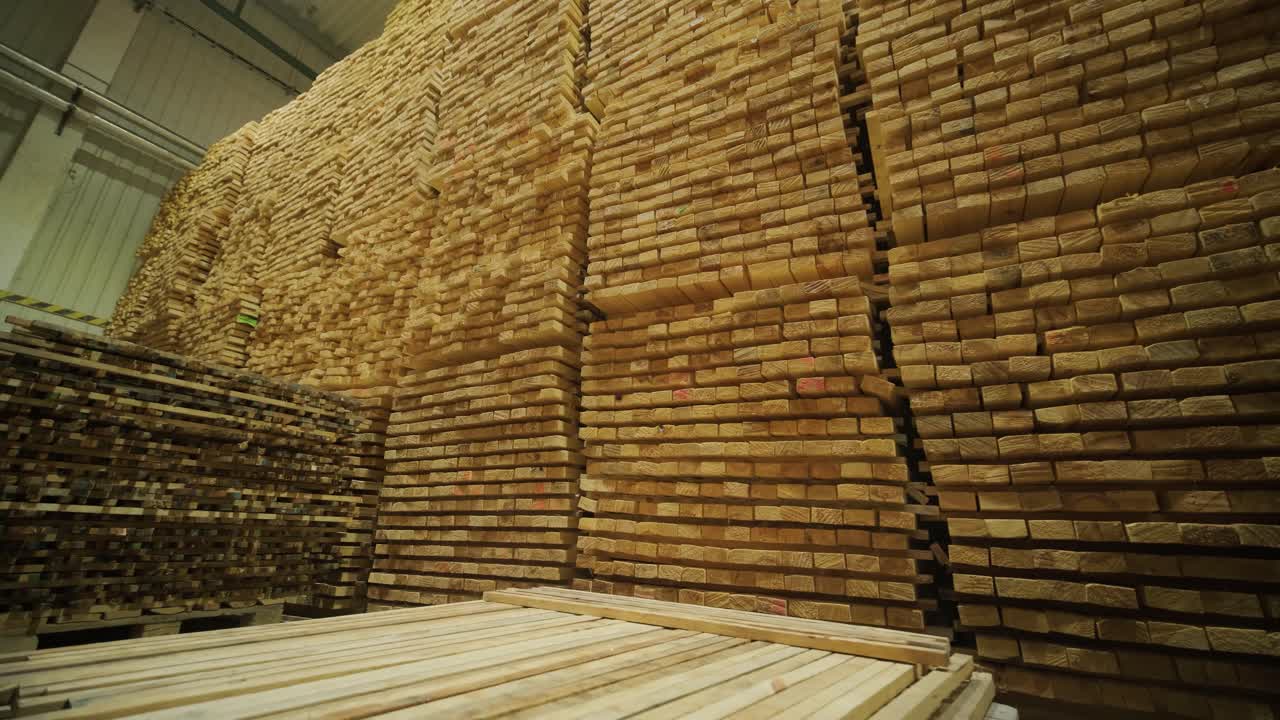 Large Stacks of Wooden Planks in an Industrial Warehouse