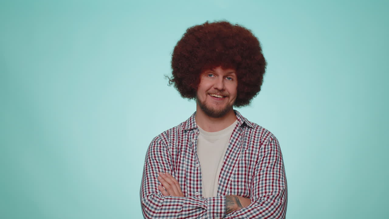 Lovely cheerful man approves suggestion, shaking head approvely, satisfied with good work, like