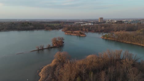 Drone-shot-flying-backwards-over-Lake-Moodie-and-Bruce-Trail-to-reveal-a-skyline-of-St