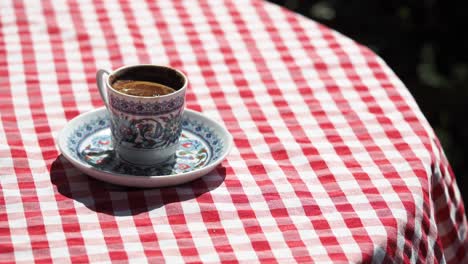 turkish coffee on a red and white checkered tablecloth